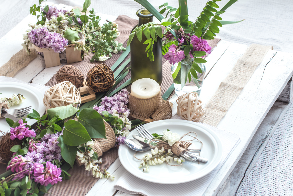 beautifully-elegant-decorated-table-for-holiday-with-spring-flowers-and-greens-wedding-or-valentine-day-with-modern-cutlery-bow-glass-candle-and-gift-horizontal-closeup-toned.jpg